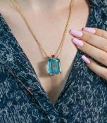 An impressive 14ct gold Aquamarine and Ruby pendant, set with one blue aquamarine with a pale tone