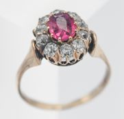 A good ruby and diamond cluster ring set in yellow gold.