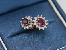 A pair of 18ct ruby and diamond cluster earrings.