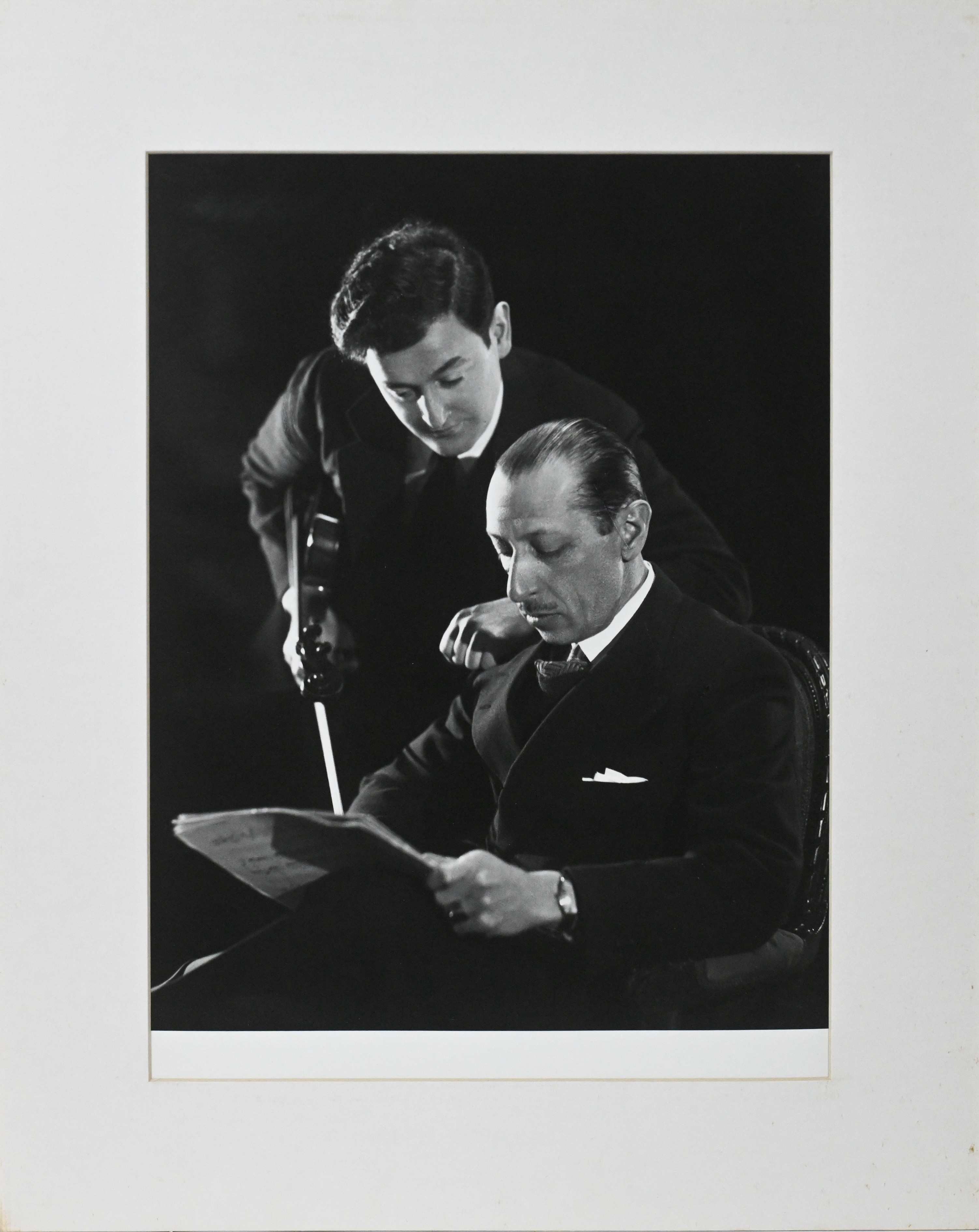 A black and white silver gelatine photographic print of two musicians, mounted, 38cm x 28cm. This