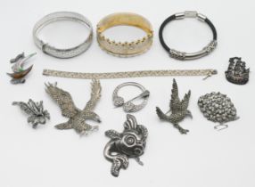 A small collection of silver jewellery to include a large silver and marcasite eagle brooch, another