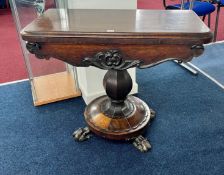 A Victorian rosewood fold over pedestal card table on claw feet, width 91cm.