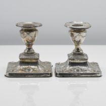 A pair of Edwardian short silver candle holders of Adam design, indistinct hallmarks for