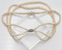 Graduated three row cultured pearl necklace, approx. length: 40cm, pearl size 4.50-7.00mm with a