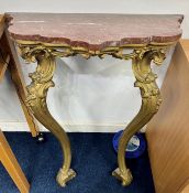 An early 19th century gilt pier table the base with gilt wood scroll legs, shaped top with
