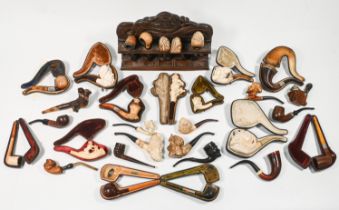 A collection of vintage smoking pipes and cigar holders. some in leather cases, approximately 120.