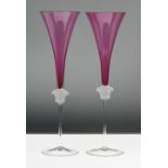 A pair of Rosenthal 'Versace' Medusa head champagne glasses, amethyst pink colour, boxed.