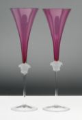 A pair of Rosenthal 'Versace' Medusa head champagne glasses, amethyst pink colour, boxed.