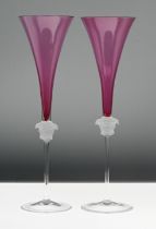 A pair of Rosenthal 'Versace' Medusa head champagne glasses, amethyst pink colour, boxed.