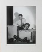 A black and white silver gelatine photographic print of a young man with a painters palette and