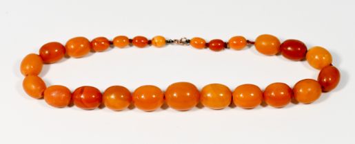 An Amber bead necklace, approx. 74.8g, with twenty four beads.