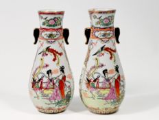 A pair of Chinese porcelain vases with matching motifs of women, birds and flowers.