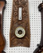 An oak carved cased two glass barometer Arts & Crafts style together with an oak carved two glass