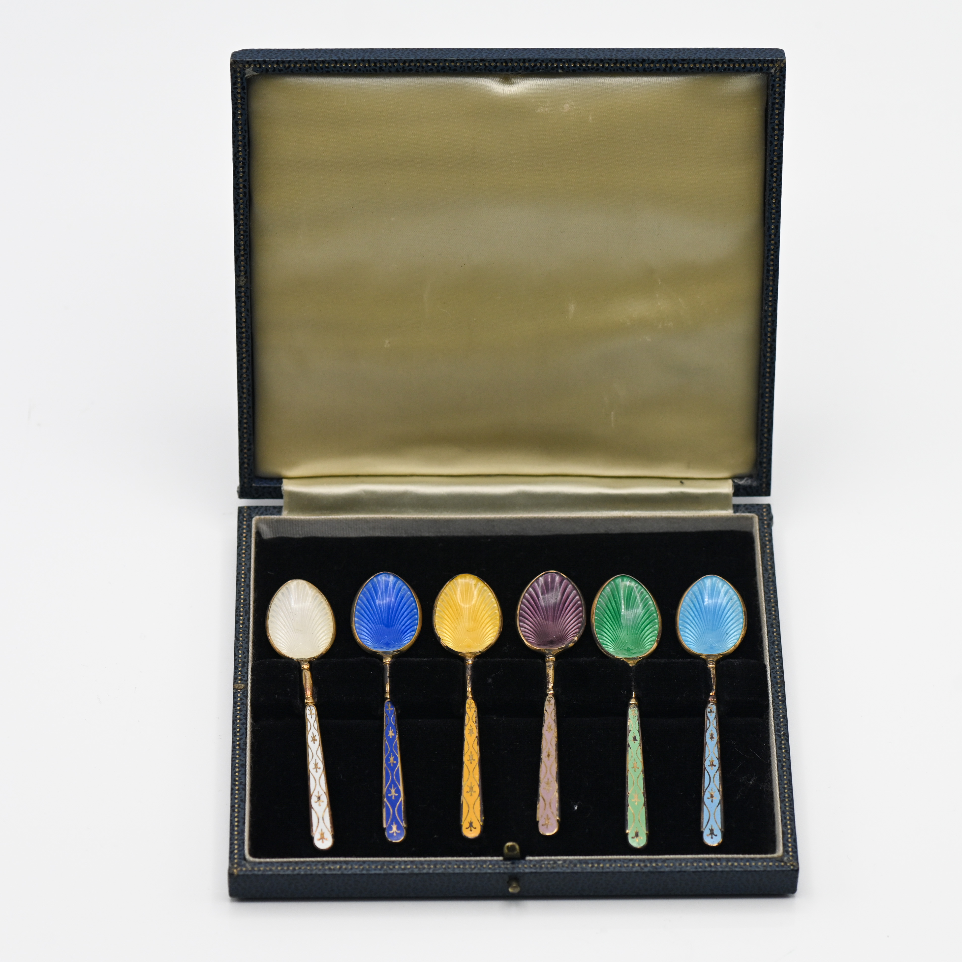 A cased set of six silver and coloured enamelled tea spoons.