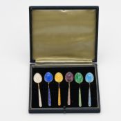 A cased set of six silver and coloured enamelled tea spoons.