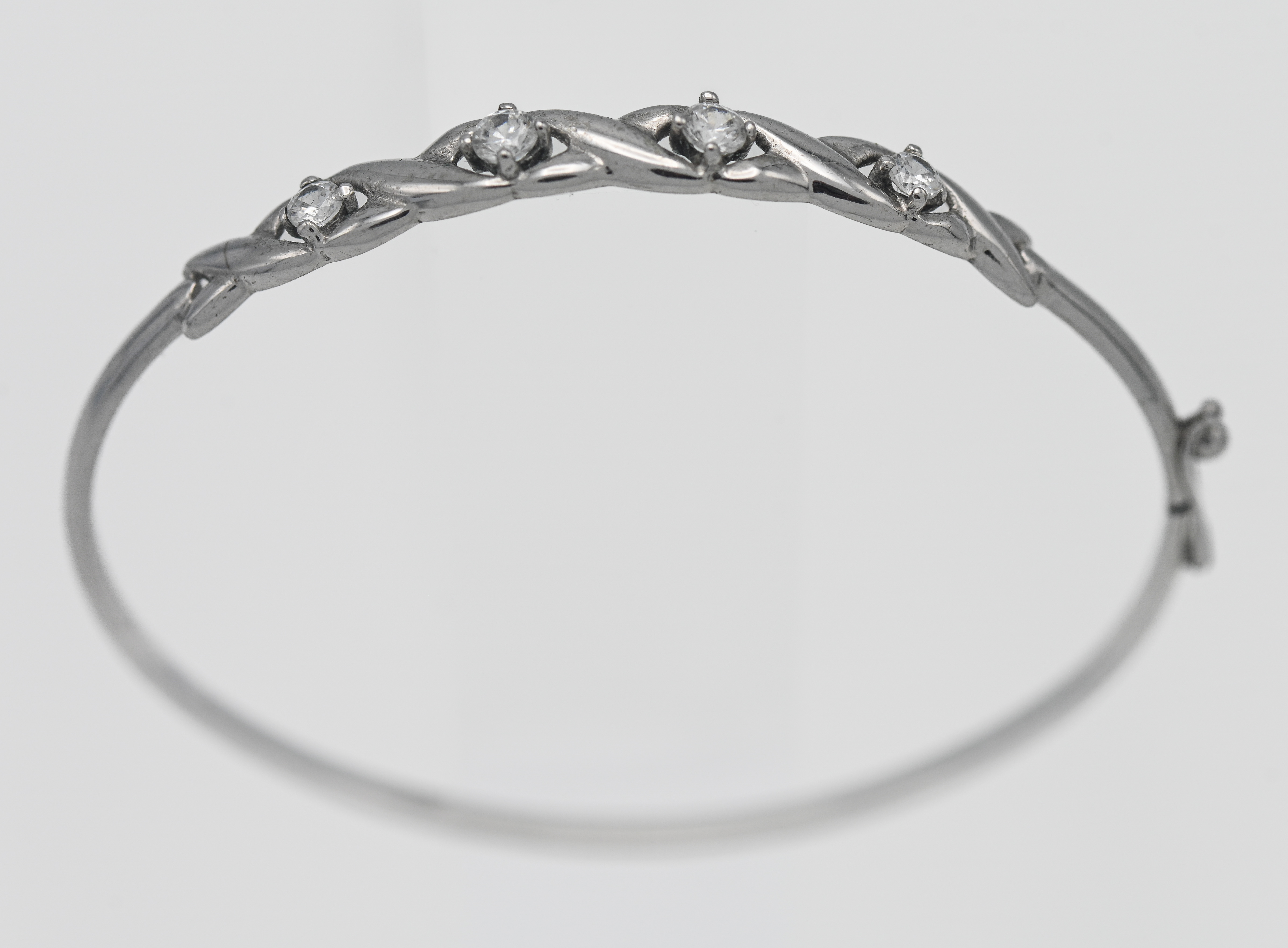 A 9ct white gold and white stone bangle, approx. 4.7g.