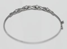 A 9ct white gold and white stone bangle, approx. 4.7g.