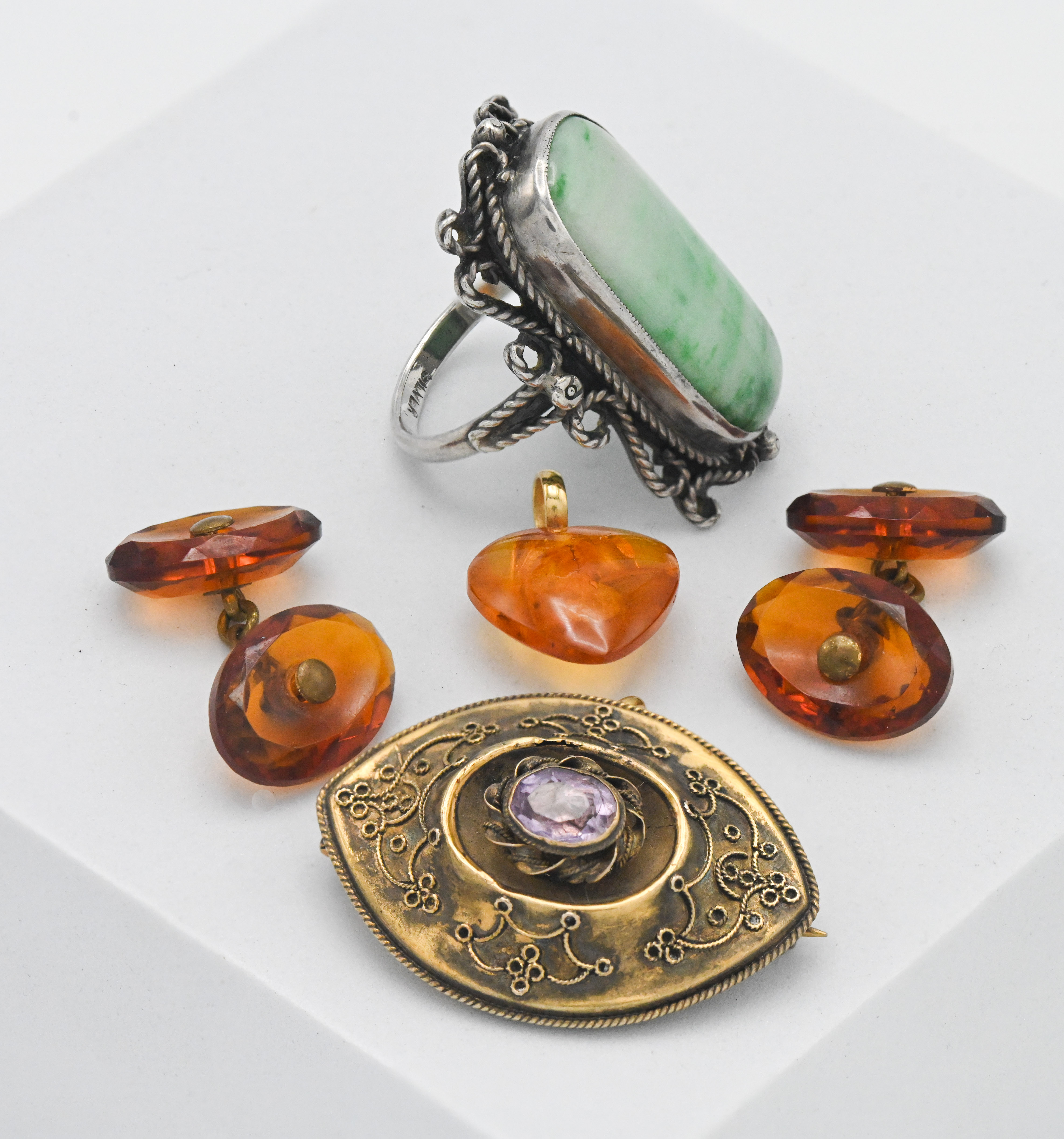 A small collection including large oriental silver jade dress ring, a pair of faceted amber