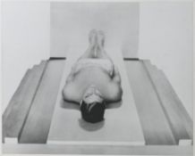 A silver gelatine photographic print, black and white image of a man laying on his back, 49cm x