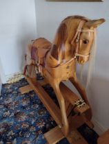 A hand carved full size rocking horse, four feet high, crafted in Devon 2002. The horse is made in