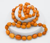 An amber necklace with graduated beads 120cm long, approx. 178g, fifty two beads. This necklace