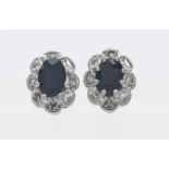 A pair of 9ct gold sapphire and diamond cluster earrings.