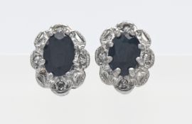 A pair of 9ct gold sapphire and diamond cluster earrings.