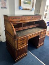 A large Louis XVI style mahogany cylinder bureau fitted with an arrangement of drawers and Pidgeon