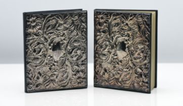 Two address books each with ornate silver embossed covers, 14cm x 11cm