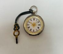 A ladies silver fob watch with roman numerals, key wind, with key.