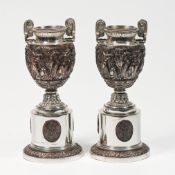A matched pair of Neo Classical urns, silver & electro form Bronze body with three matching oval