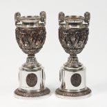 A matched pair of Neo Classical urns, silver & electro form Bronze body with three matching oval