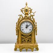 A brass mantle clock with bell strike and movement marked 'Fans Hallan' height 36cm with key.