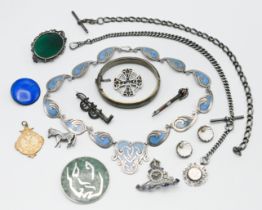 An assortment of silver jewellery to include silver horse brooch, silver albert chain, brooches