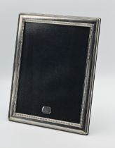 A modern sterling silver photo frame, with easel wood back, 30cm x 25cm
