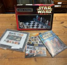 An assortment of Star Wars merchandise including a Star Wars chess set, two sets of Star Wars