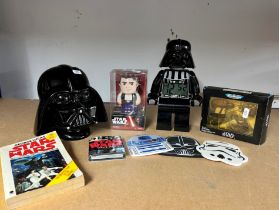 A collection of Star Wars items including, Hans Solo tin wind up by Disney, Darth Vader money box,