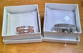 Swarovski Atelier, one gold wrap three strand bracelet and one three strand expanding silver arm