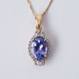 An 18ct yellow gold pendant set with an oval tanzanite, approx. 1.27 carats, surrounded by small