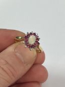 An 18ct yellow gold diamond and opal cluster ring, size W.