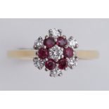 An 18ct yellow & white gold flower design cluster ring set with diamonds & rubies, total diamond