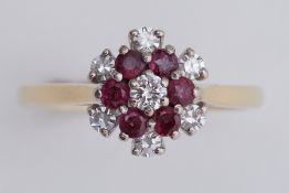 An 18ct yellow & white gold flower design cluster ring set with diamonds & rubies, total diamond