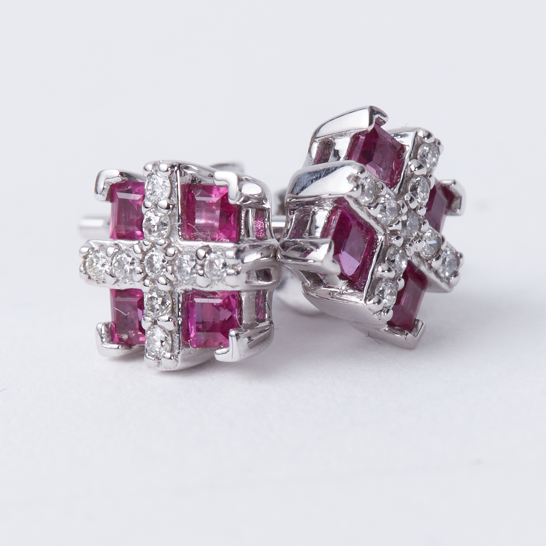 A pair of 18ct white gold square shaped studs set with square shaped rubies & small round