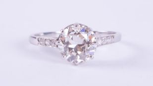 An Art Deco platinum (no hallmark & not tested) ring set with a central older round cut diamond,