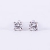 A pair of platinum studs set with a round brilliant cut diamond, total diamond weight 0.20 carats,