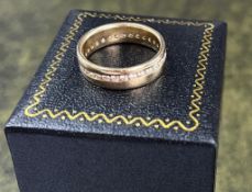 An 18ct yellow gold and diamond band ring, size P.