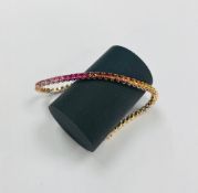 An 18ct rose gold multi coloured sapphire bracelet, length 18cm.