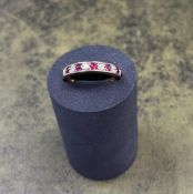 An 18ct yellow gold diamond and ruby half eternity ring, size P/Q.