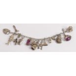 Silver charm bracelet with 17 assorted charms, 64.4g.