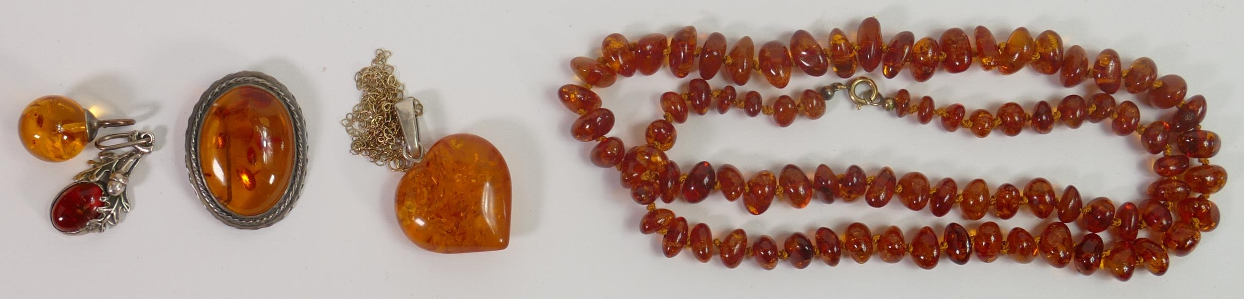 A collection of Silver mounted Amber jewellry, amber bead necklace etc